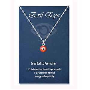 Close-up of Evil Eye protection necklace with red eye pendant on blue message card