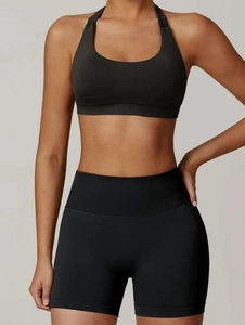 Close-up of black halter yoga bra and high waist shorts with ribbed waistband detailing