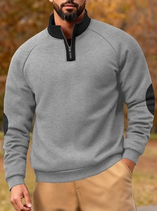 Close-up of grey fleece sweatshirt featuring black stand collar and elbow patches