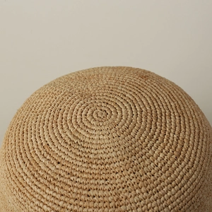 Macro view of detailed spiral hand-woven raffia texture on a summer sun hat