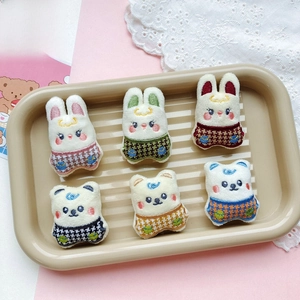 Detail of assorted plush animal patches featuring cartoon bears and rabbits in outfits