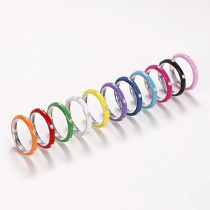 Rainbow enamel stainless steel rings with zircon inlay set on a clean white background