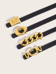 Detail showing four styles of black leather belts with gold metal buckles and matte finish