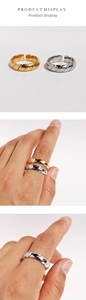 Detailed view of adjustable twisted rope rings in gold and silver finishes on hand