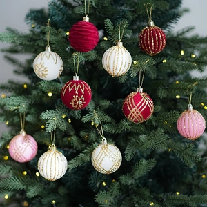 Christmas tree ornaments set with red and white velvet balls on green pine branches