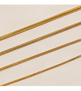 Detailed view of four golden snake bone chains with high-quality metallic finish and texture