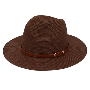 Detailed macro view of woven straw texture and brown faux leather band on Panama hat
