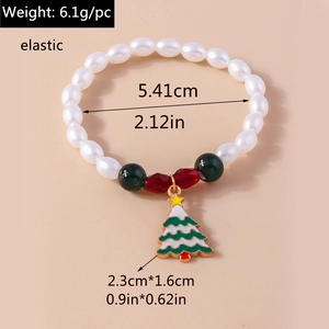 Detail of Christmas beaded bracelet with enamel tree charm and pearl accents