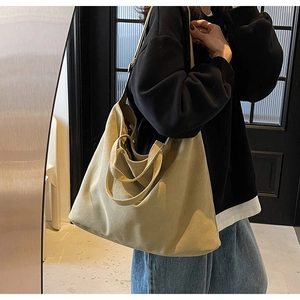 Detail view of large khaki canvas tote bag showing side draping and spacious capacity