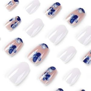 Short press-on nails with blue watercolor flowers and glossy white finish on white background