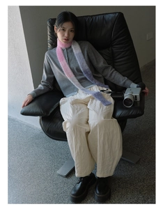 Detail shot of a slim Y2K gradient scarf in pink and purple on a stylish model