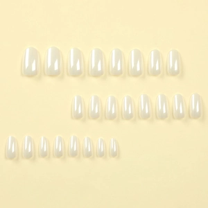 Set of 24 white laser finish oval press-on nails in various sizes on a soft yellow background