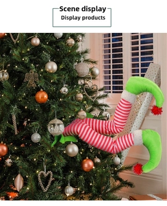 Close-up of striped Christmas elf legs hanging on a decorated tree with red pom-pom details