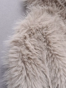 Macro detail of soft beige faux fur texture with high density and fluffy long fibers