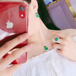 Mirror selfie showing the elegant green chalcedony jewelry set worn by a female model