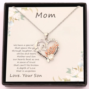 Macro shot of heart pendant engraved with Mom and I love you forever in a gift box