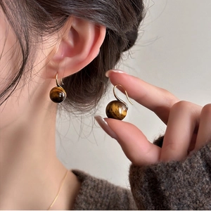 Elegant tiger eye stone earrings with minimalist gold hooks in a retro aesthetic