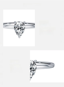 Macro detail of pear-shaped D color VVS1 moissanite ring set in 925 sterling silver