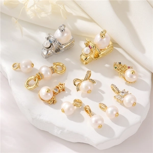 Elegant 14K gold plated pearl connectors with crown and bow charms on stone plate