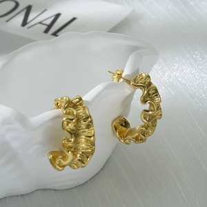Elegant gold irregular wave earrings in luxury stainless steel with textured finish