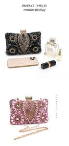Detail view of crystal evening clutch bag with peacock feather pattern and chain
