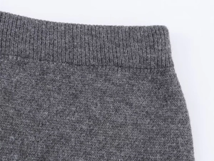 Detailed close-up of dark grey jacquard knit waistband with elastic ribbed texture