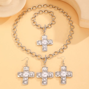 Silver cross jewelry set with necklace and earrings featuring inlaid white pearls