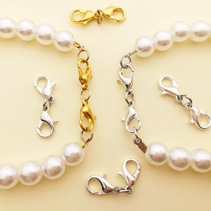 Dual-head lobster clasp connectors in gold and silver finish for pearl necklaces