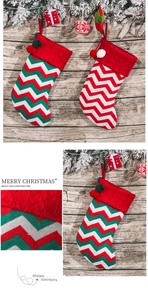 Close-up of knitted Christmas stockings with wavy patterns on a rustic wooden background