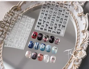 Detail of 3D embossed bow and heart nail stickers on various colored manicures