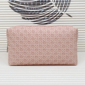 Pink cosmetic bag with 3D woven texture and zipper closure for travel storage