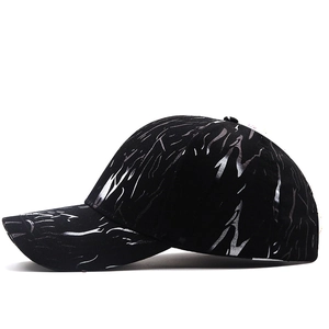 Detail view of the black baseball cap showing shiny silver metallic tiger stripe patterns