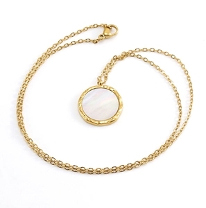 Detailed shot of 18K gold plated necklace with round shell pendant and textured edges