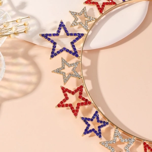 Detailed close-up of red, blue and white rhinestone stars on golden metal headband