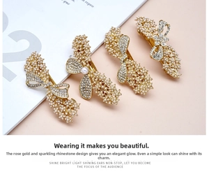 Detailed view of elegant bow hair clips with pearls and rhinestones on rose gold metal