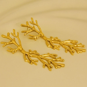 Detailed view of 18k gold plated stainless steel earrings in coral branch design