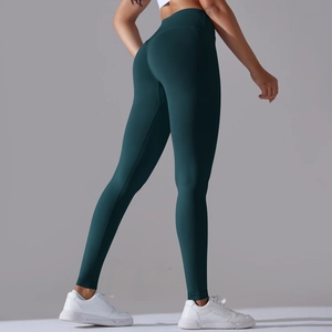 Detail view of seamless dark green yoga pants with high waist scrunch butt lifting effect
