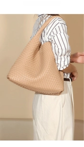 Close-up of woven shoulder bag in apricot beige, highlighting the vegan leather texture
