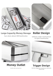 Detail of silver money gun toy showing 300-bill capacity and internal roller mechanism