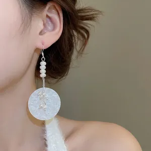 Elegant pearl drop earrings with large circular pendant and silver chain for women