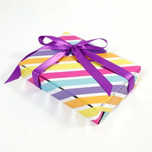 Colorful striped gift box with diagonal pastel stripes and a purple satin ribbon bow