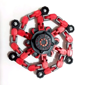 Macro view of a red and black mechanical fidget spinner with transformable chain arms