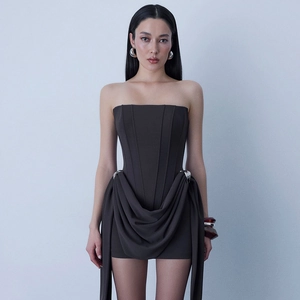 Detailed view of dark grey strapless dress featuring waist metal buckle and draped fabric