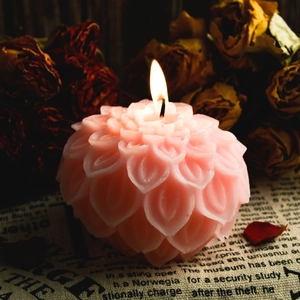 Detailed view of 3D lotus flower candle with realistic petals lit on vintage linen