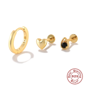 Detailed macro of gold sterling silver earrings set with S925 hallmark and black gemstone