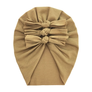 Detail of baby mustard yellow turban hat with triple knot bows and ribbed cotton texture