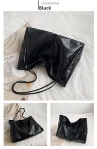 Detail view of large black tote bag with vintage pleated leather and thin shoulder straps