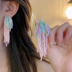 Detail of handmade colorful beaded fringe earrings with vibrant pastel macaron beads