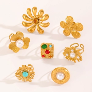 Bohemian gold ring set with vintage floral designs, turquoise, and white pearls