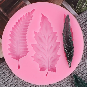 Pink silicone leaf mold for fondant cakes and crafts with finished green leaf model